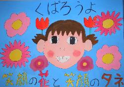 「くばろうよ 笑顔の花と笑顔のタネ」という標語が入っており、笑顔の女の子の周りにたくさんのお花が描かれています。