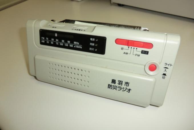 画像：「鳥羽市防災ラジオ」という文字が書かれた携帯ラジオの写真